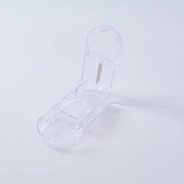 Transparent pill cutter included with the organiser